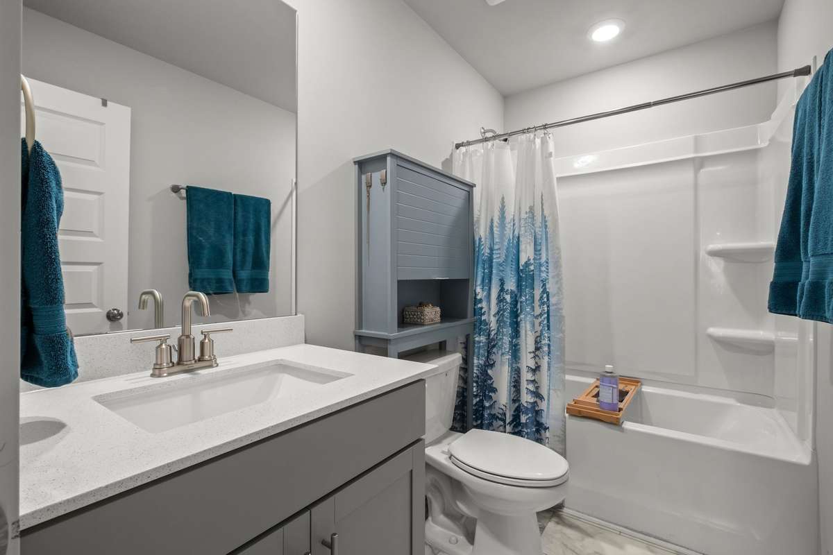 This full bath is at the end of the hall by Bedroom 3 and 4.