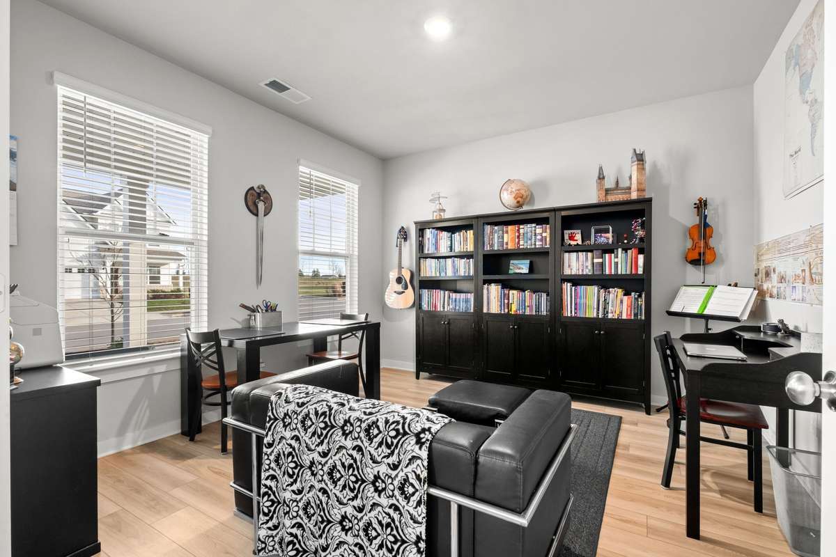 Two large windows flood the office space with light.