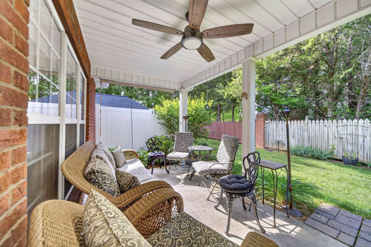 Covered patio with ceiling fan.