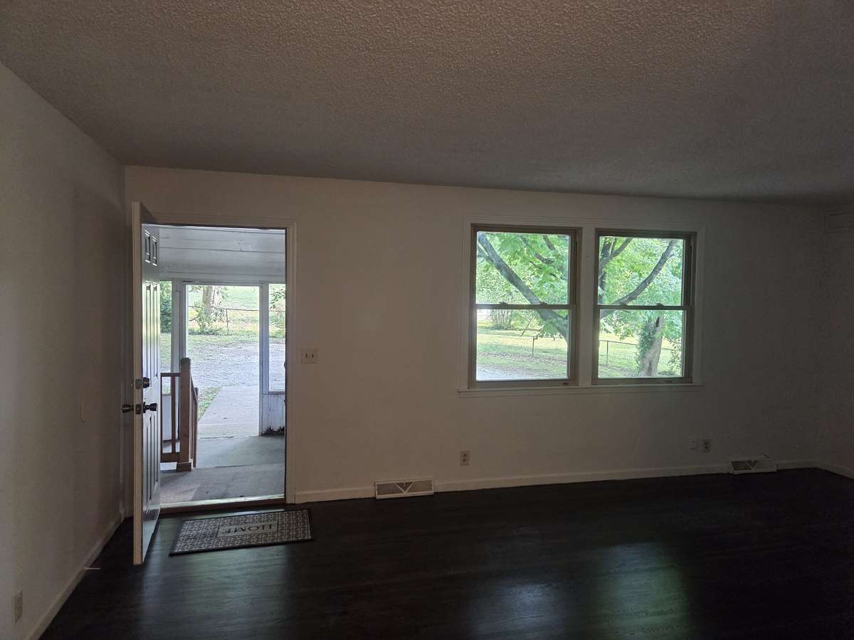 Den with access to screened in back porch