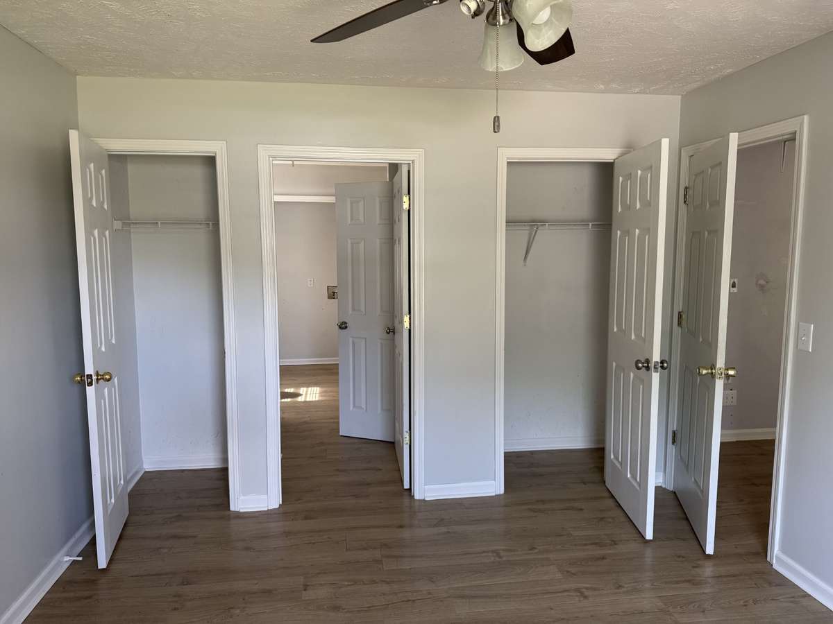 Double closets in primary bedroom.  Middle door provides access to full primary bath and laundry.