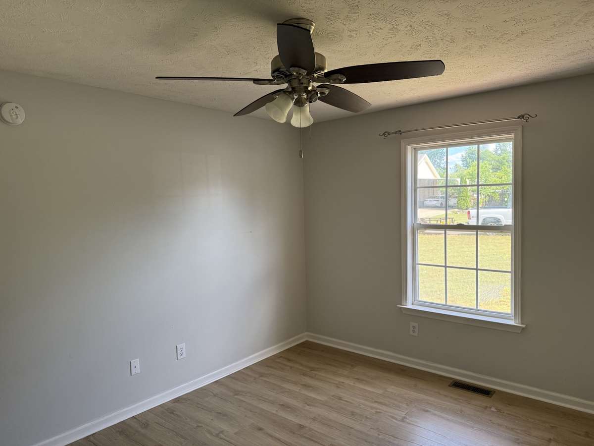 Ceiling fan also located in primary bedroom.