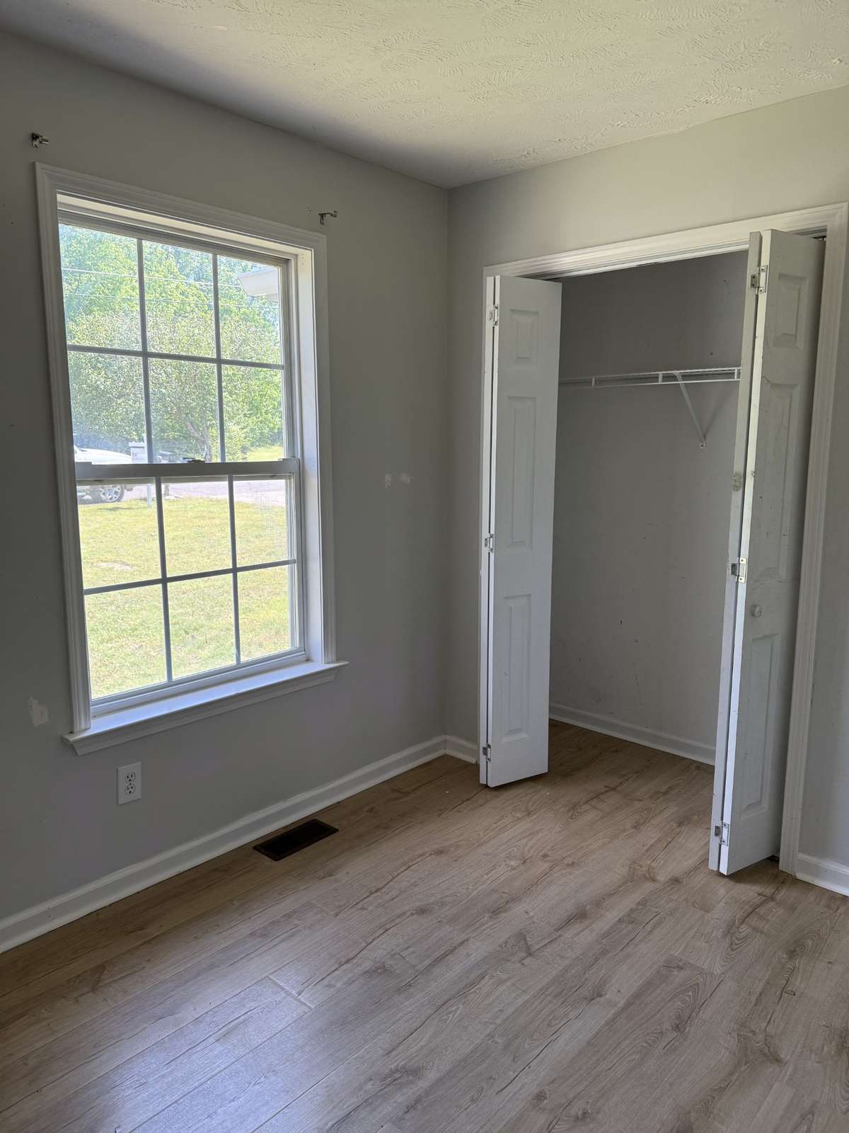 Second bedroom located at front of the home with bi-fold door closet access.