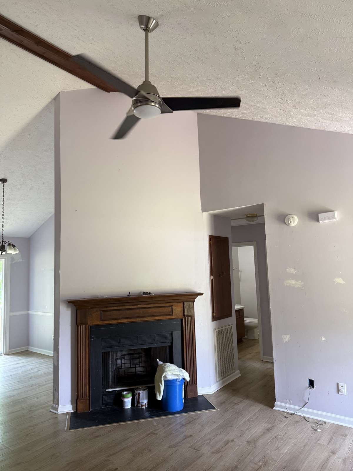 Volume ceiling and ceiling fan in living room.