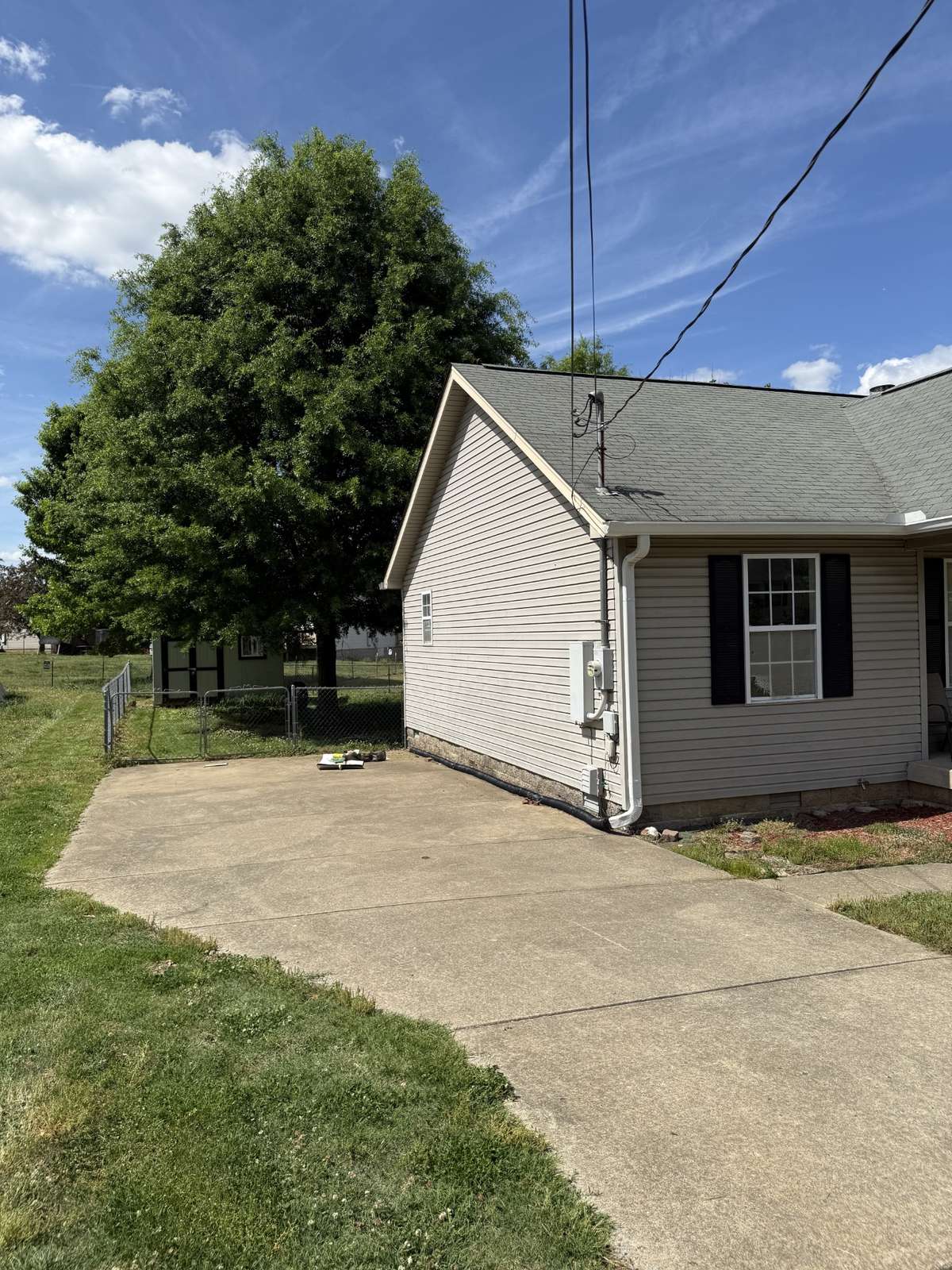 Extended parking area beside home.