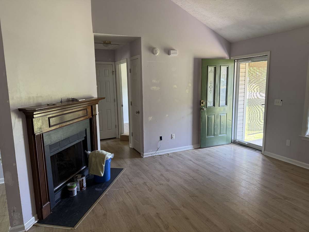 Small hallway off living room leads to two bedrooms and a full bath.