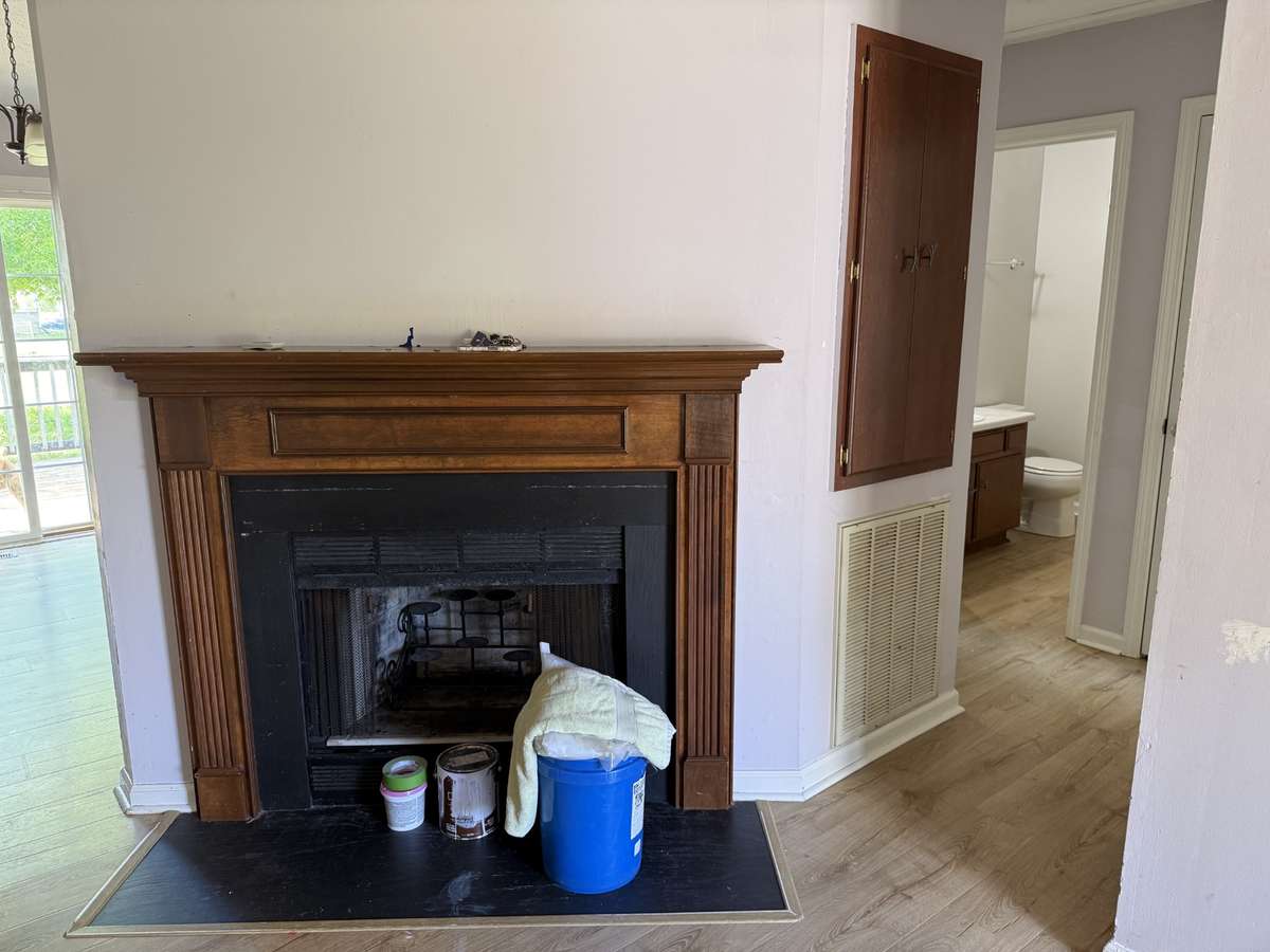 Wood burning fireplace with stained mantle.