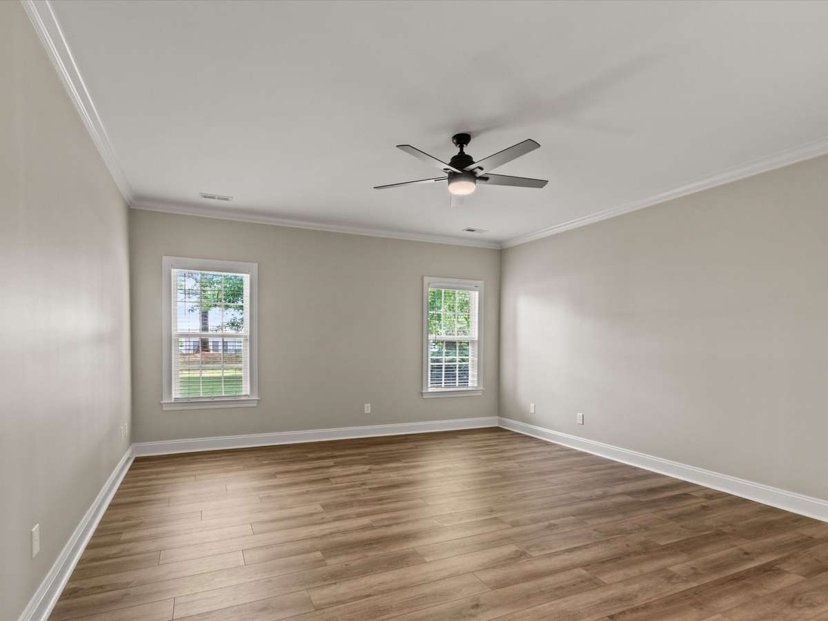 Bedroom- LVP flooring, crown molding, ceiling fan