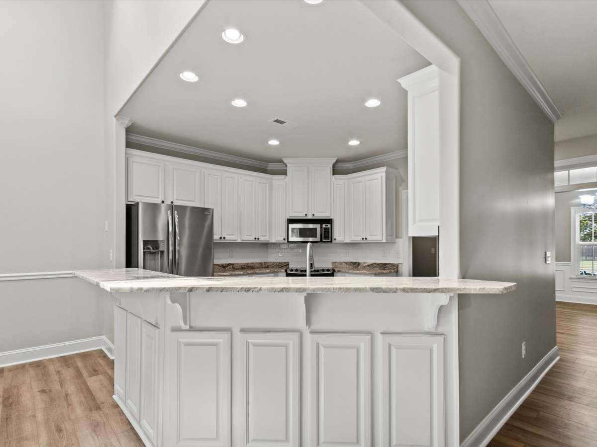 Kitchen- LVP flooring, crown molding recessed lighting, granite countertop, eat in kitchen, pantry, stainless steel appliances
