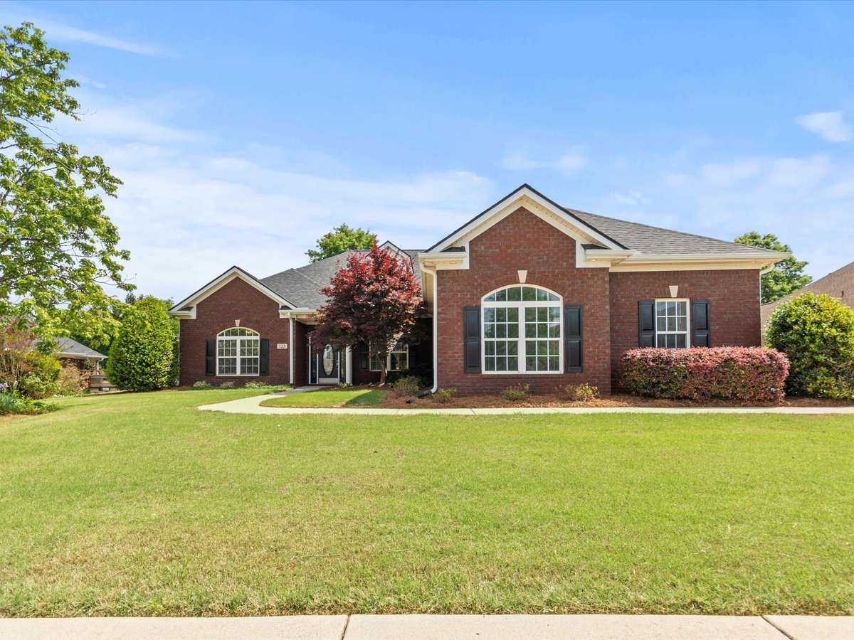 Front of house - Full brick, concrete driveway and sidewalk, beautiful landscaping, covered front entry