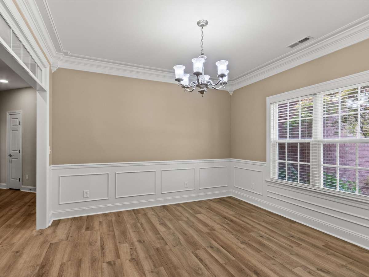 Dining Room -LVP flooring, wainscotting, crown molding, 9' ceiling