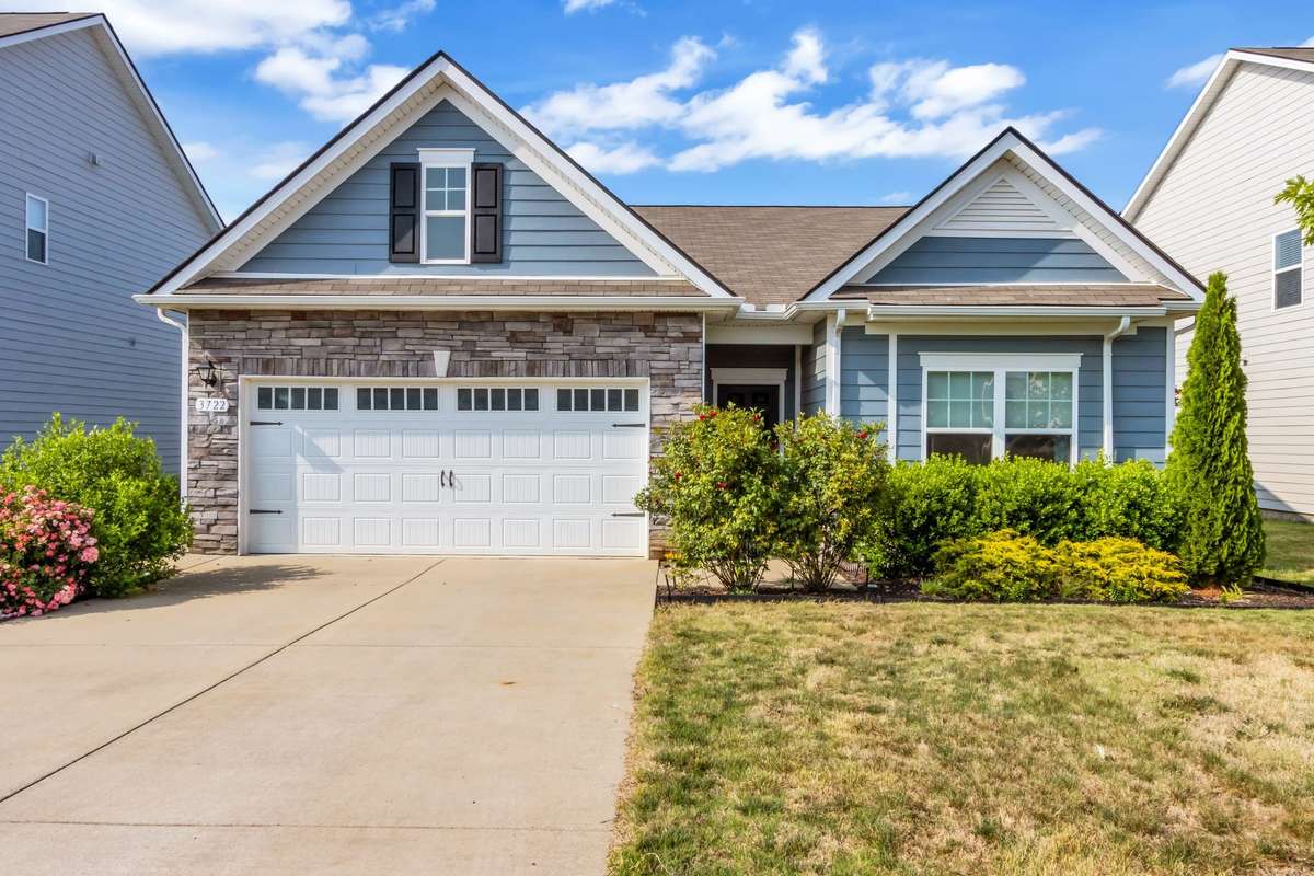 Stunning curb appeal welcomes you with a beautiful stone façade, thoughtful landscaping, and charming architectural details that make a lasting first impression.