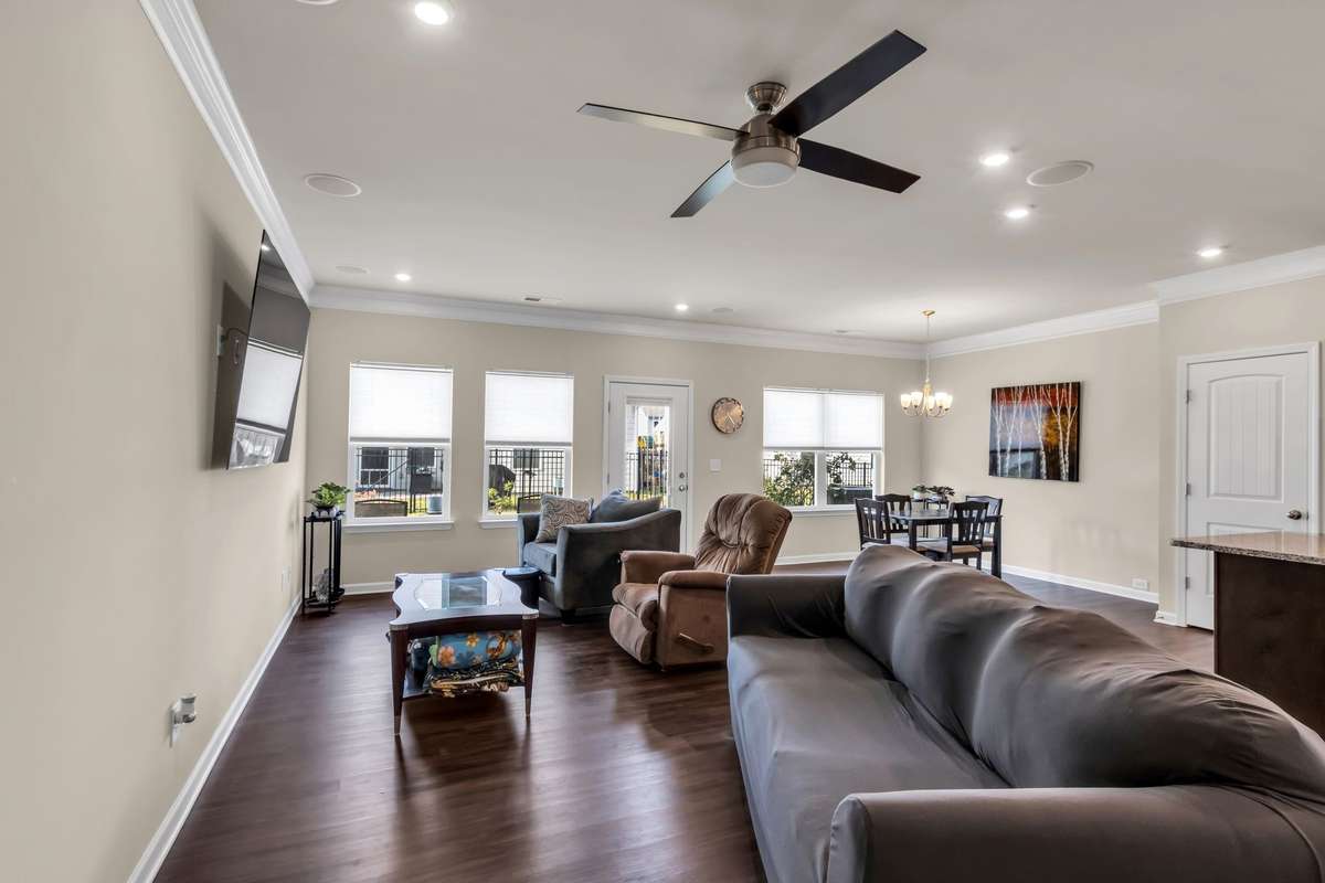 Bright and airy living area offers an open layout, beautiful flooring, recessed lighting, surround sound, and effortless flow to the dining space, perfect for gatherings.