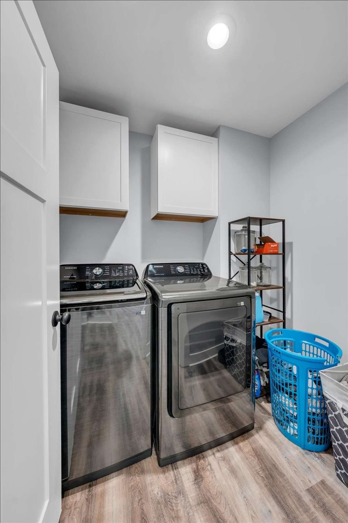 Utility room with luxury vinyl flooring and cabinets.  Washer & dryer are negotiable.