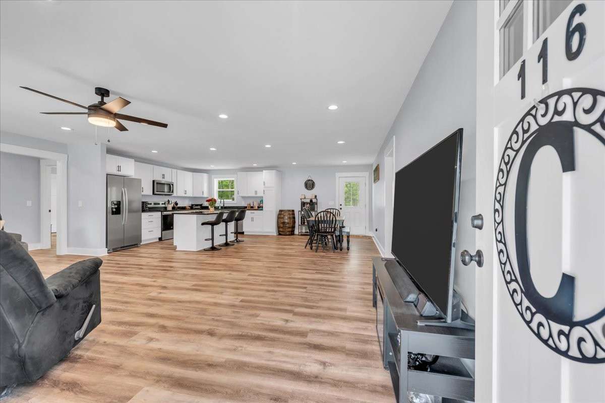 Step inside to a spacious living room that seamlessly flows into the kitchen and dining area.