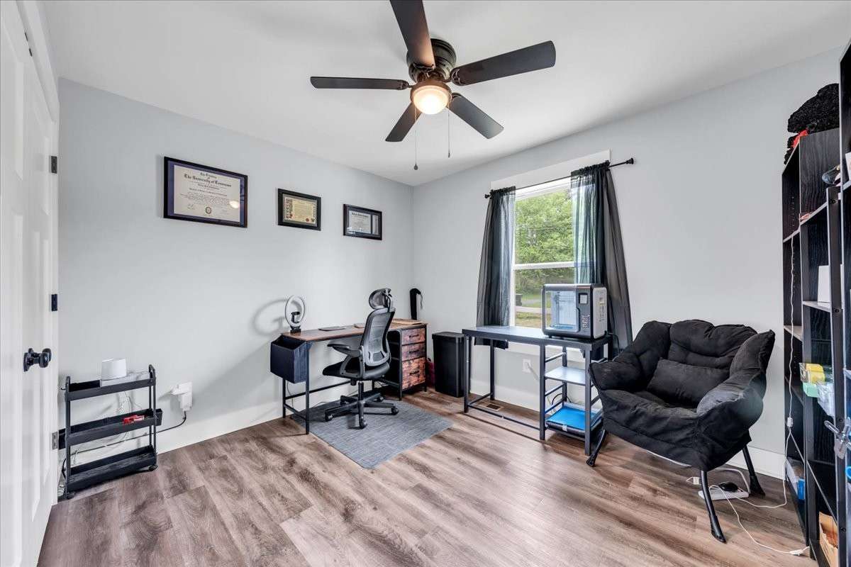 Third bedroom with luxury vinyl flooring, ceiling fan and large closet.
