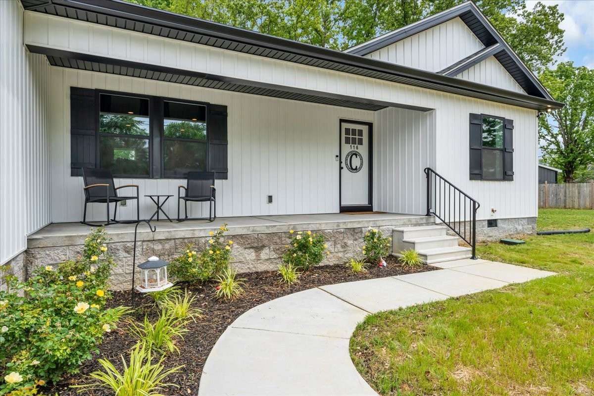 Delightful covered front porch, perfect for enjoying morning coffee or evening relaxation.