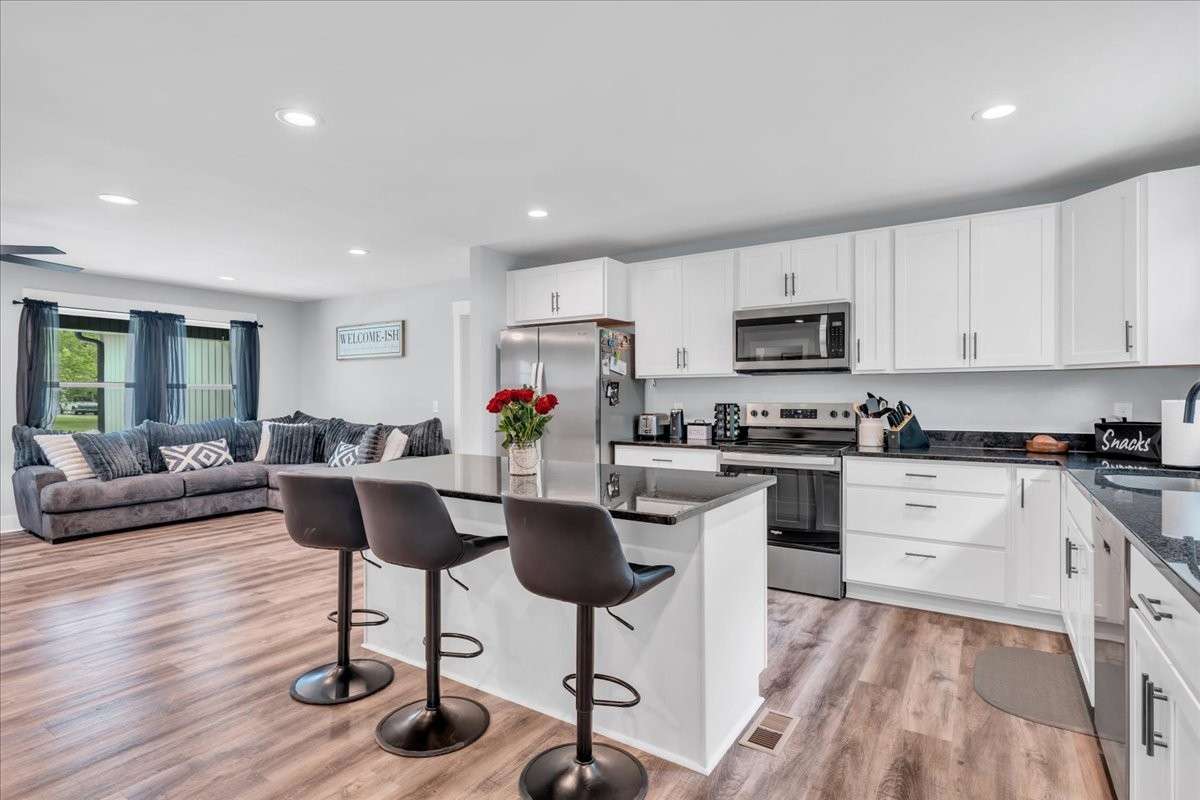 Equipped with sleek stainless steel appliances, this kitchen combines functionality with modern elegance.