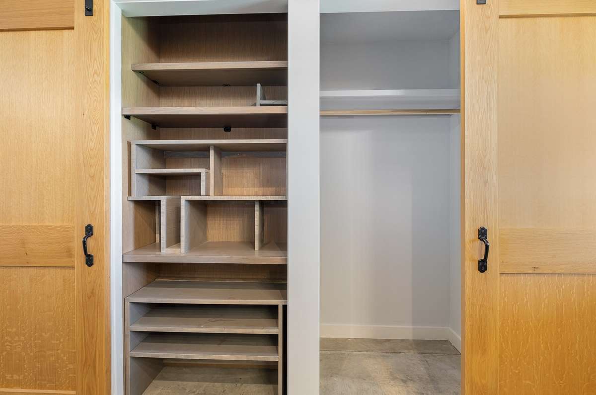 Another one-off feature is the stylish and functional shelving that is adjacent to the kitchen. Maybe you also use this one as a pantry? Whatever you choose to use it for, cabinetry like this is rare and can be costly to add. It's already here!