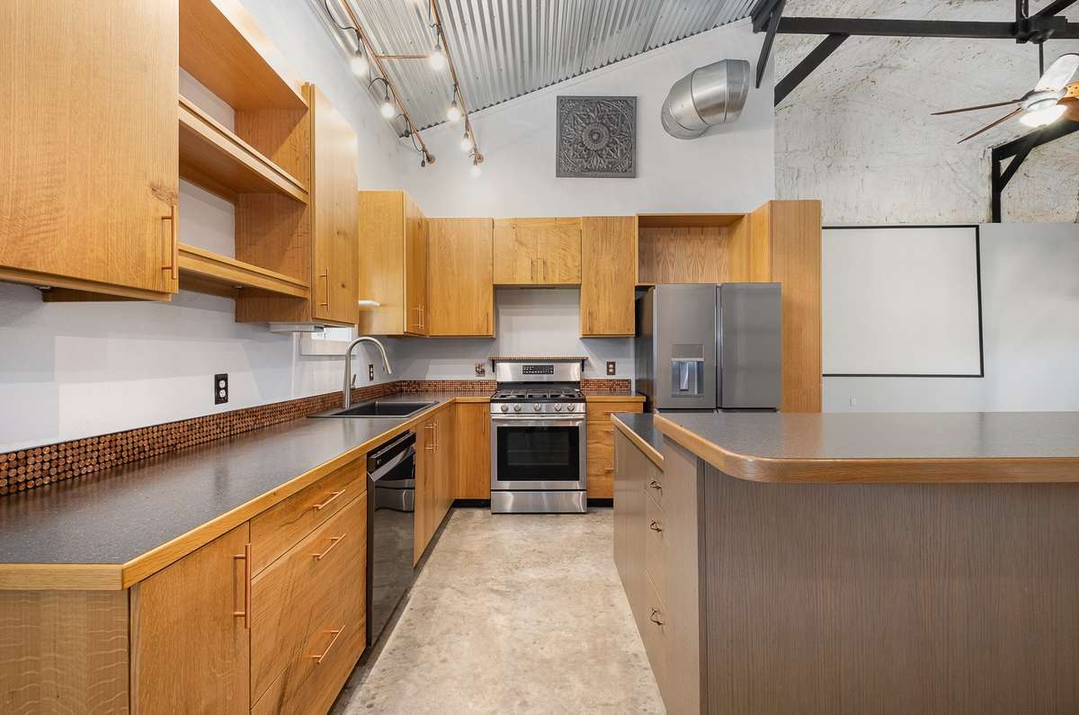 Well appointed with newer stainless appliances, a farmhouse style sink, and distinctive trim details, this kitchen is a highlight of the property. And just look at all the cabinet storage and counter space.