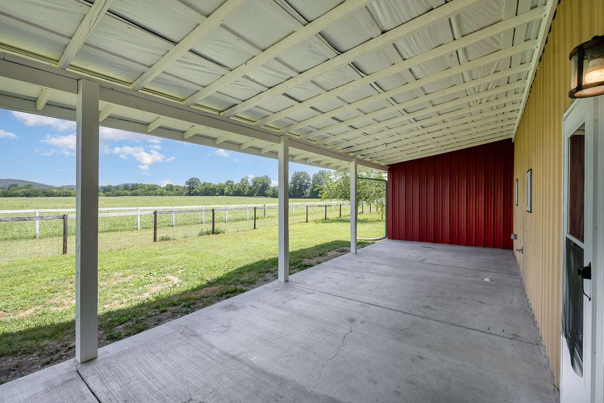 The spacious covered porch can be a gathering place to relax and enjoy your favorite beverage, or, maybe you park the ATV's here while you grab a snack after some morning recreation.