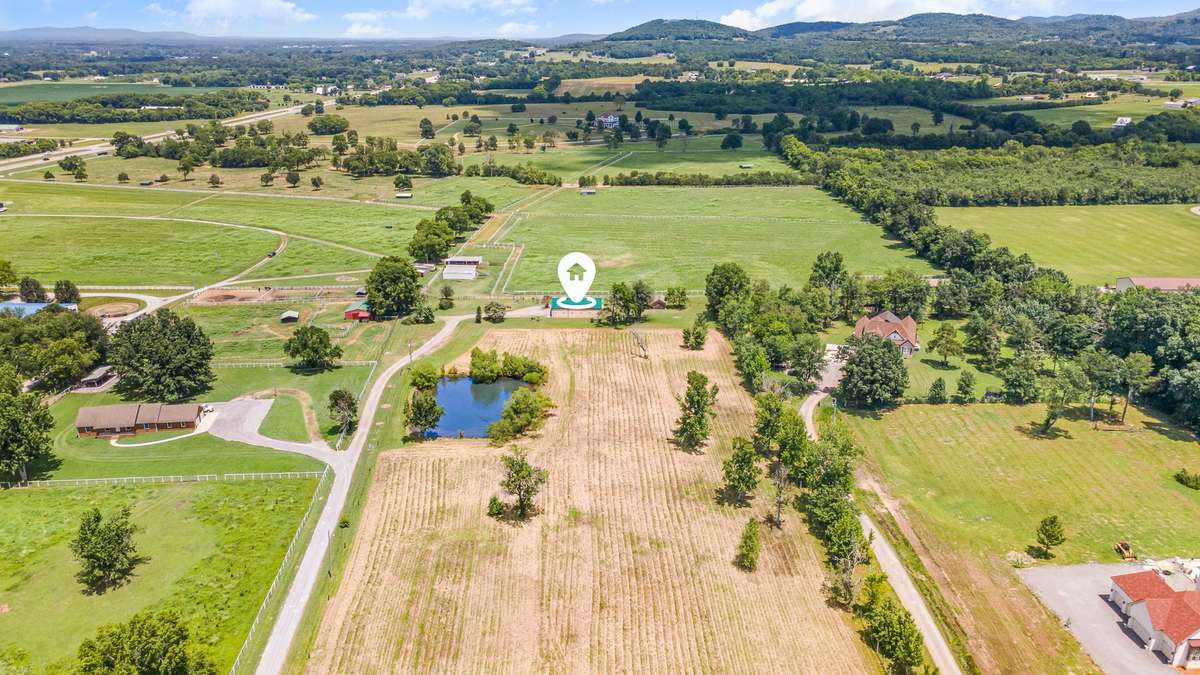 Aerial shot with home pinned, showing overall layout and location within surrounding properties.