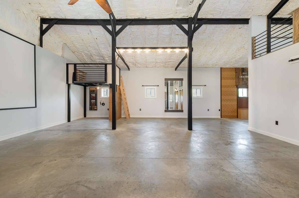 This view is from the kitchen area, looking back across the main living area. Take a look at the natural light the four windows in this photo let in.