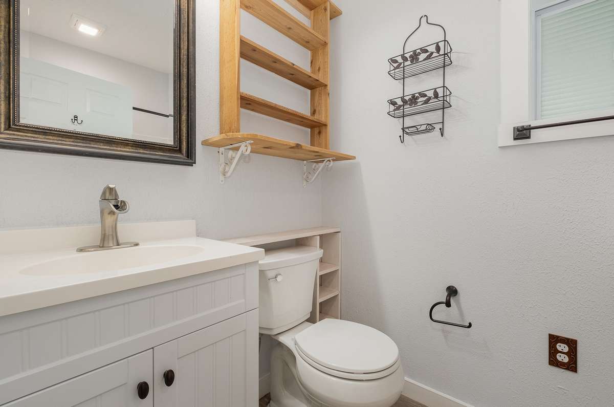 The home's bathroom offers a single vanity, stylish fixtures, and a shower / tub combo.