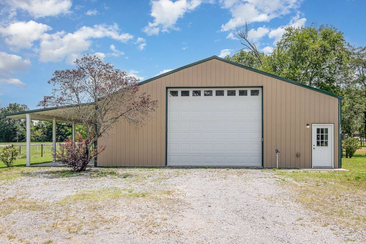At 2,400 square feet total under roof and an additional huge covered porch, (pictured in the left side of this photo) this one has plenty of room for the outdoor toys as well!