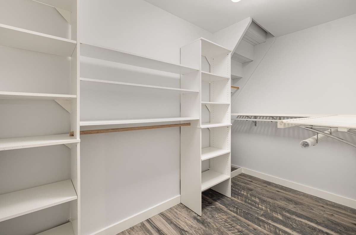 Walk-in closet attached to the bedroom. Custom cabinetry in here as well. Think of the time, money, and effort, having this already installed saves you.