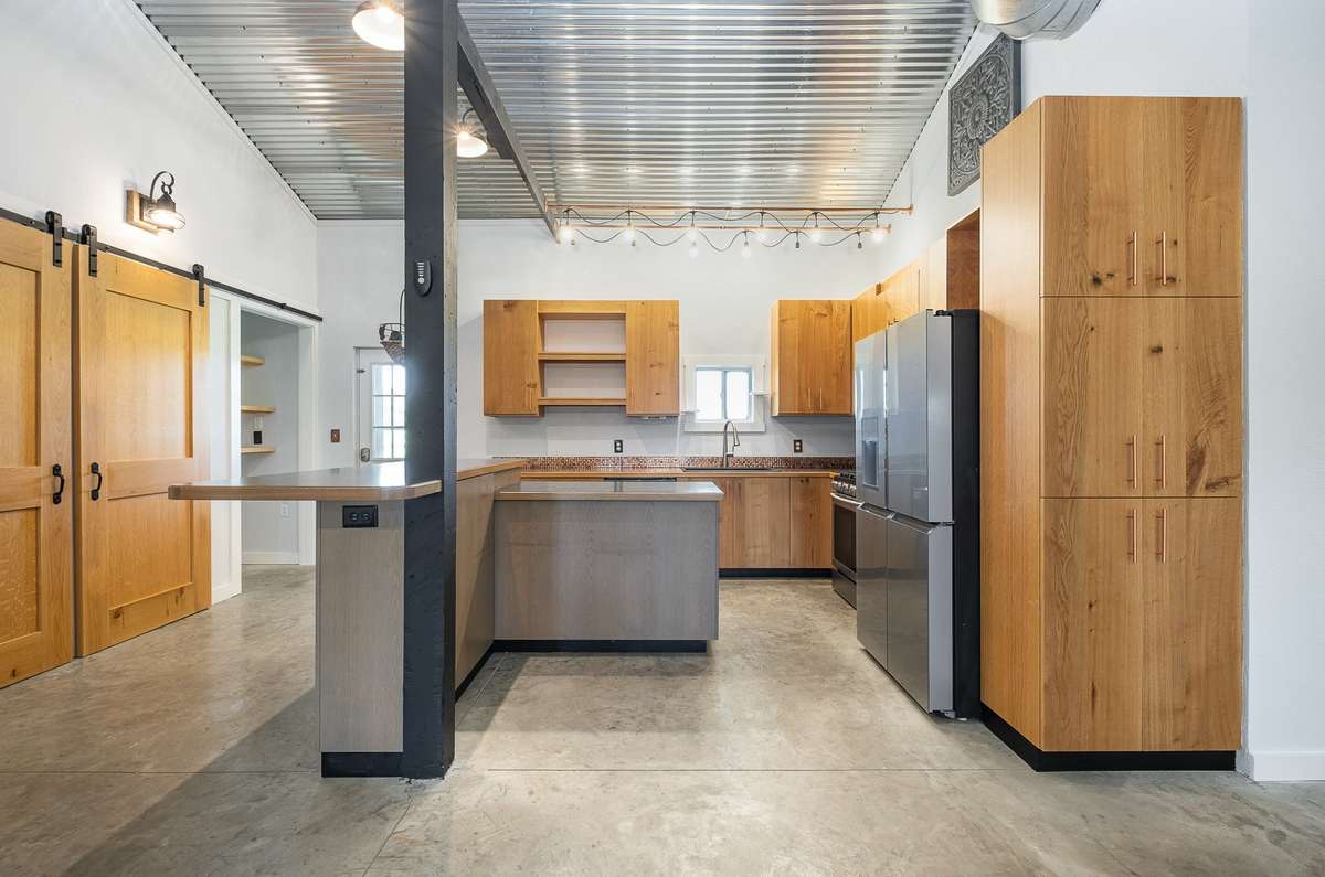 This barndominium was a labor of love and you won't find a kitchen like this in any other home.  The cabinets are truly one-off, custom builds that speak to the care and consideration given to the home's overall design.