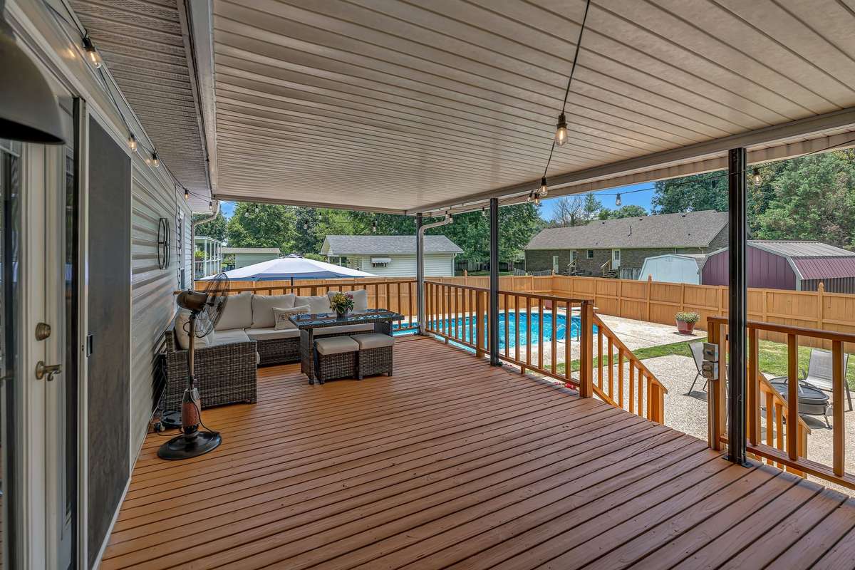 Covered Porch overlooking pool and fire pit
