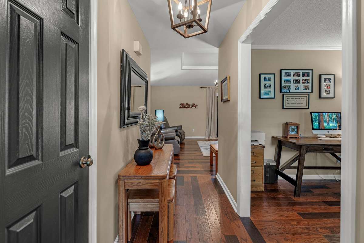 Foyer opens to home with upgraded engineered hardwood floors