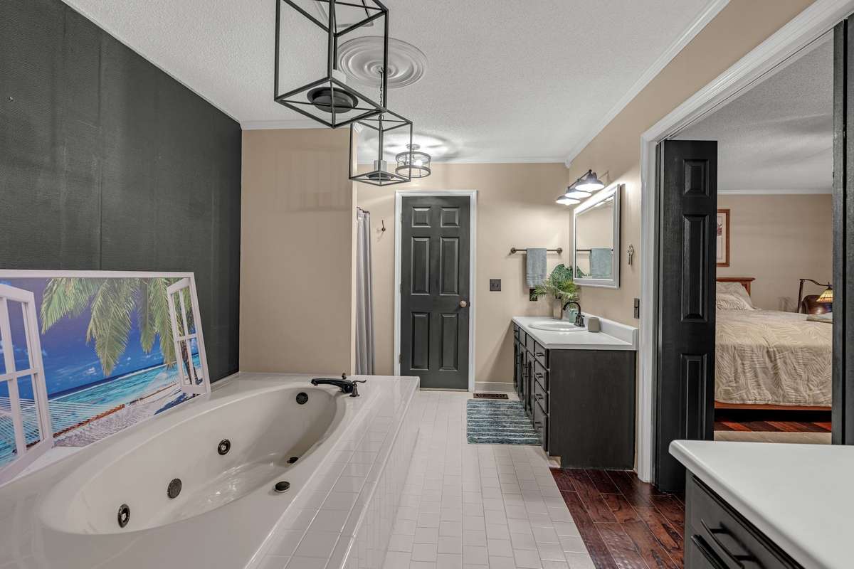 Large Primary Bathroom with double vanities, private water closet, whirlpool tub and shower