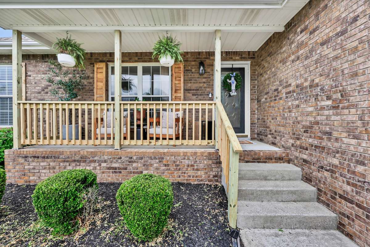 Relax under your covered porch! Porch railing just got replaced as an added bonus!