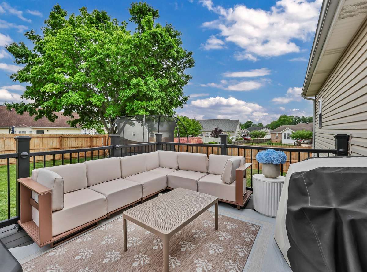 Take a step out back to a large deck + privacy fenced yard
