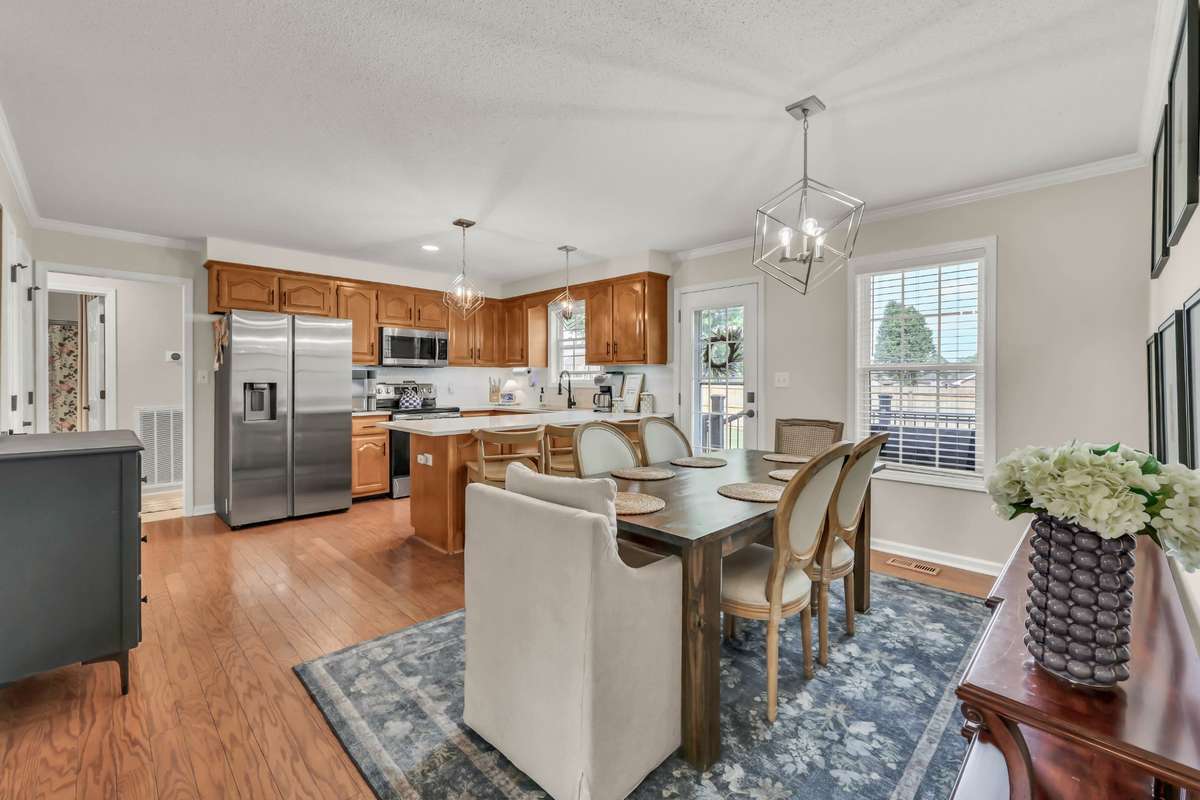 Spacious kitchen with hardwood floors + updated lighting
