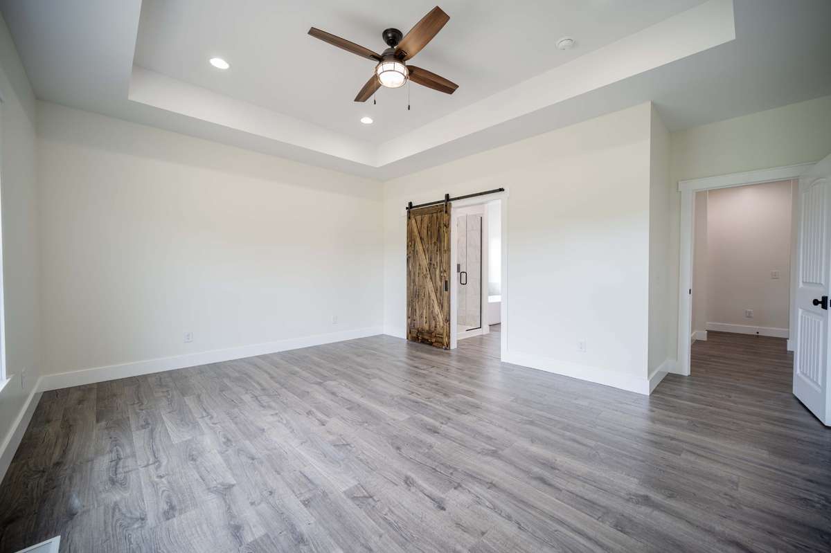 Master Suite with Barn Door Entrance to Master Bath