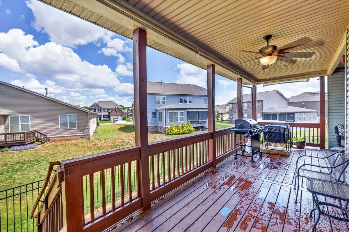 L-Shaped covered back deck area includes electrical outlets, lighting, and ceiling fans