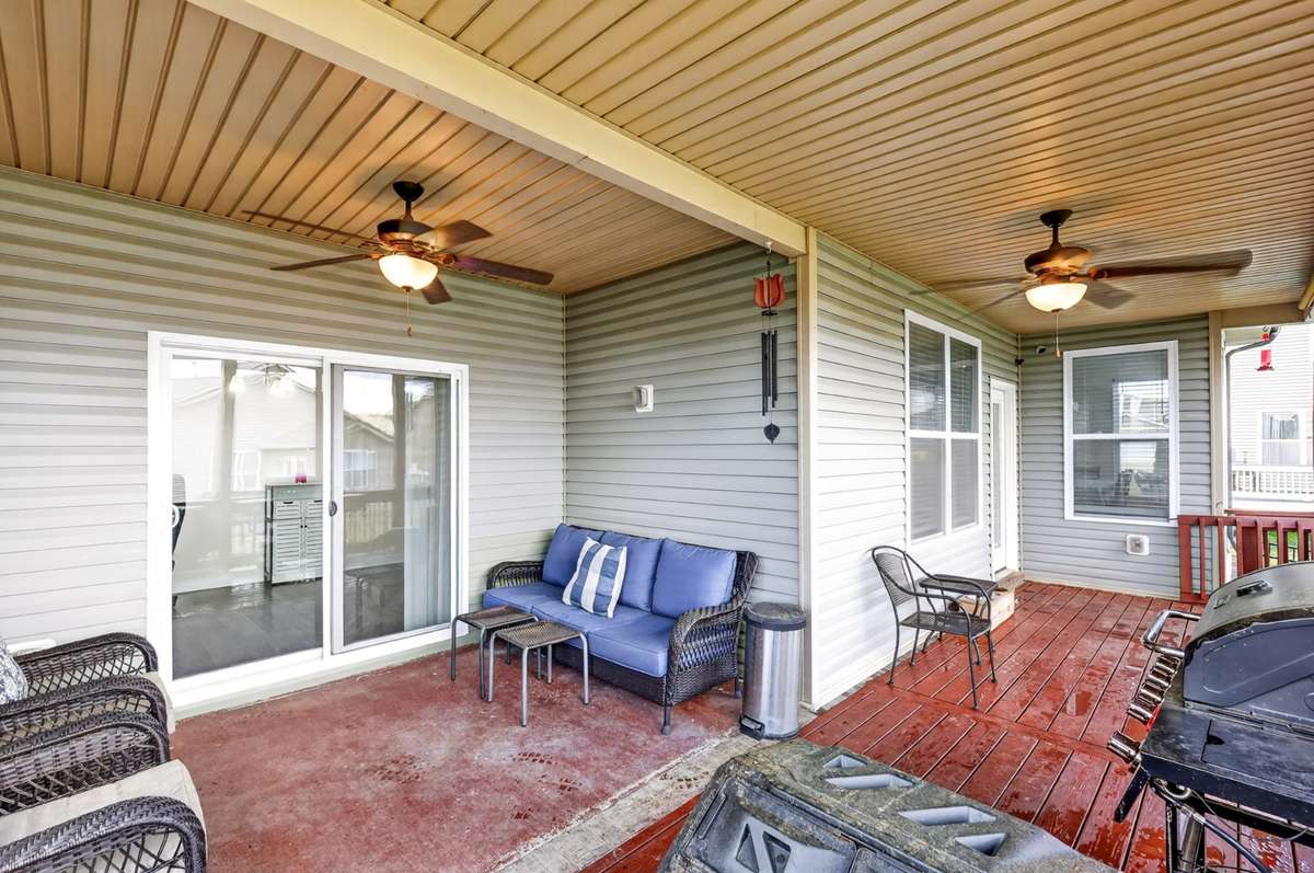 L-Shaped covered back deck area includes electrical outlets, lighting, and ceiling fans