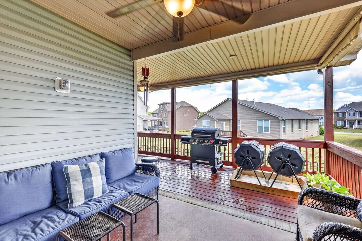 L-Shaped covered back deck area includes electrical outlets, lighting, and ceiling fans