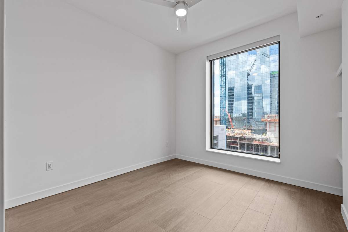 A statement-making feature, this oversized window spans nearly the entire wall, filling the bedroom with natural light and creating an open, airy feel.