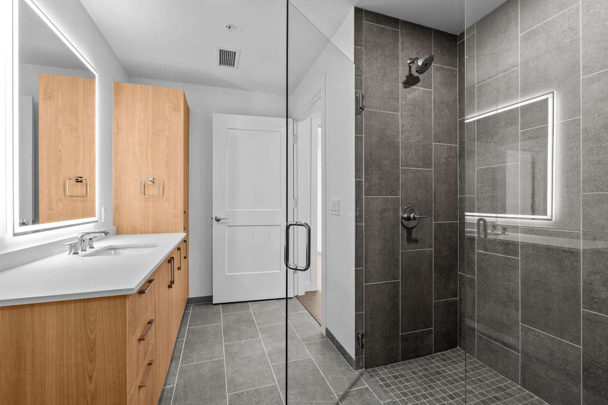 Spacious bathroom featuring an extra-long vanity with ample counter space—perfect for storage and everyday functionality.