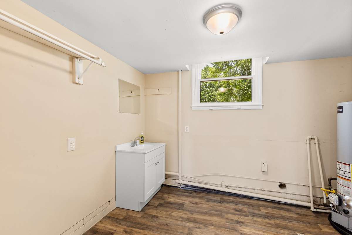 The utility room houses the water heater (gas), washer & dryer connections and a half bath (toilet not seen here).