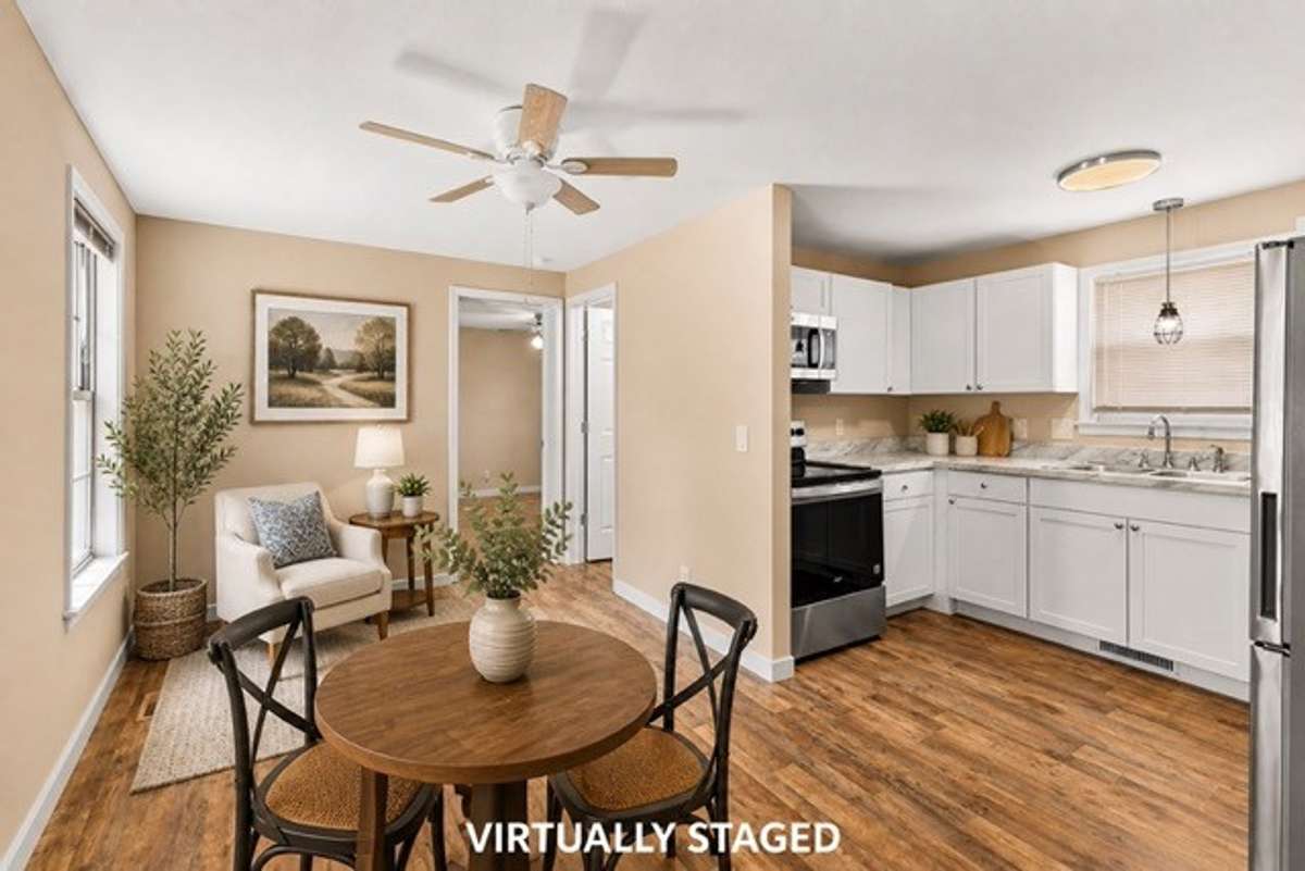 Here it is staged with a reading nook and small dining table. There is a full bath just off the kitchen/living combo.
