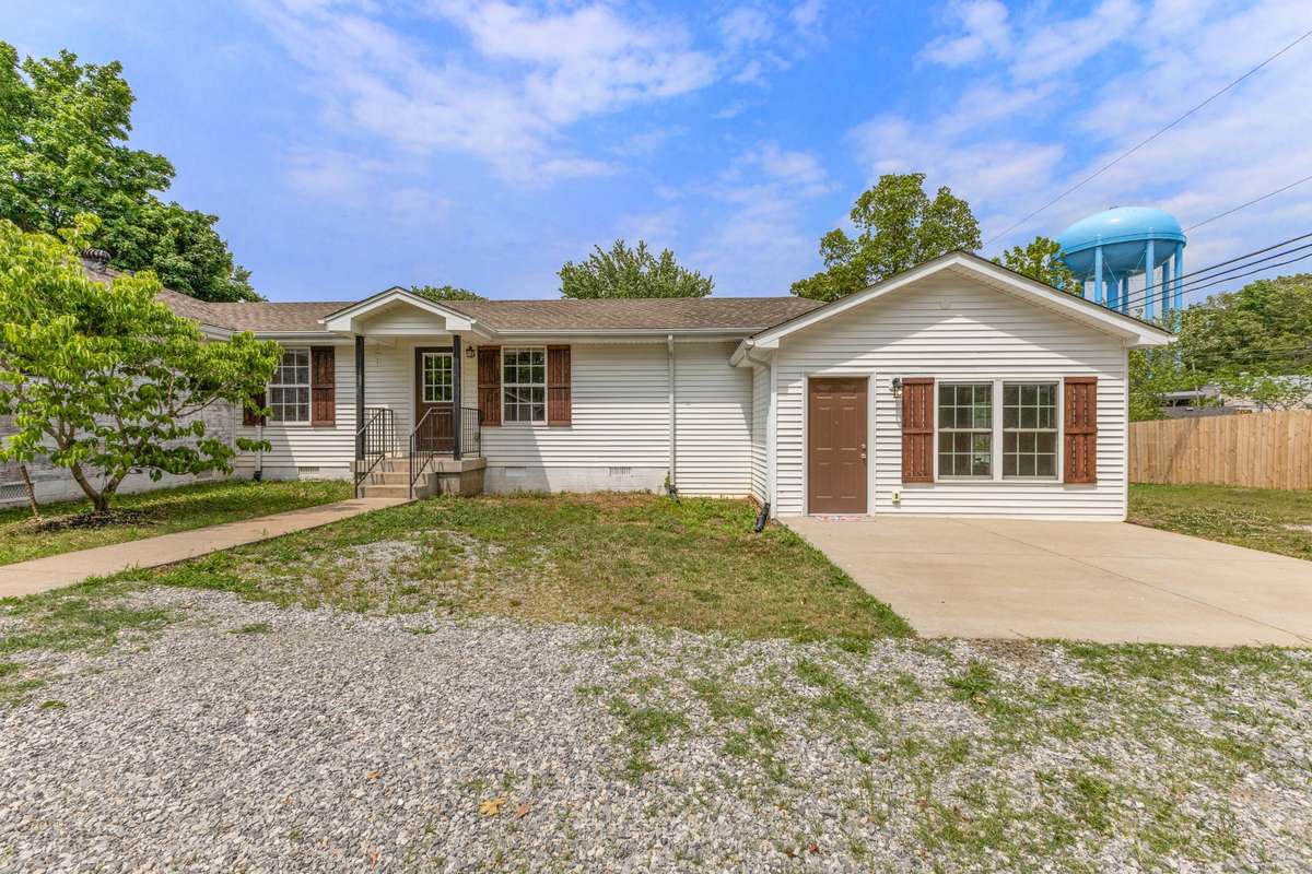 This shows the addition with its covered entry, large patio/paved space.