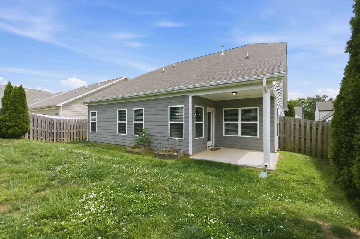 Spacious and sunny back yard is fully fenced.