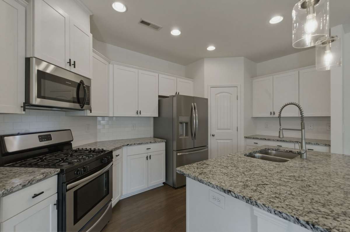 Stainless appliances include gas range, microwave, refrigerator and dishwasher.