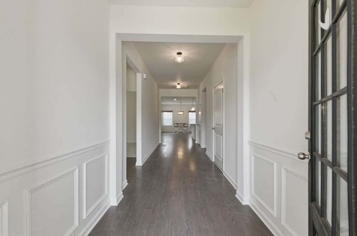 As you enter the front door you'll notice the beautiful wood floors and accessible wide foyer and hall. The guest bedrooms and bathroom are to the left.