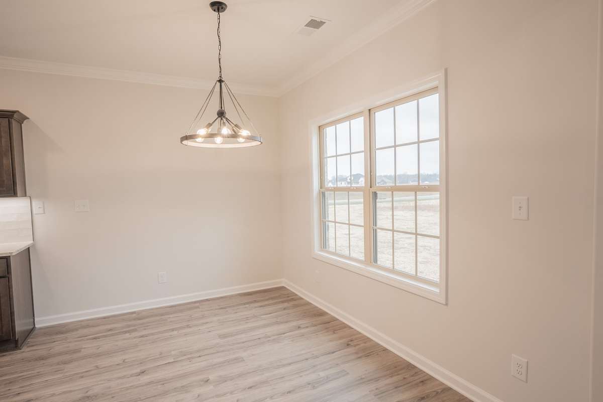 EXAMPLE >>>Eat-In Area with a Beautiful Chandelier and Natural Lighting Overlooking the Backyard!